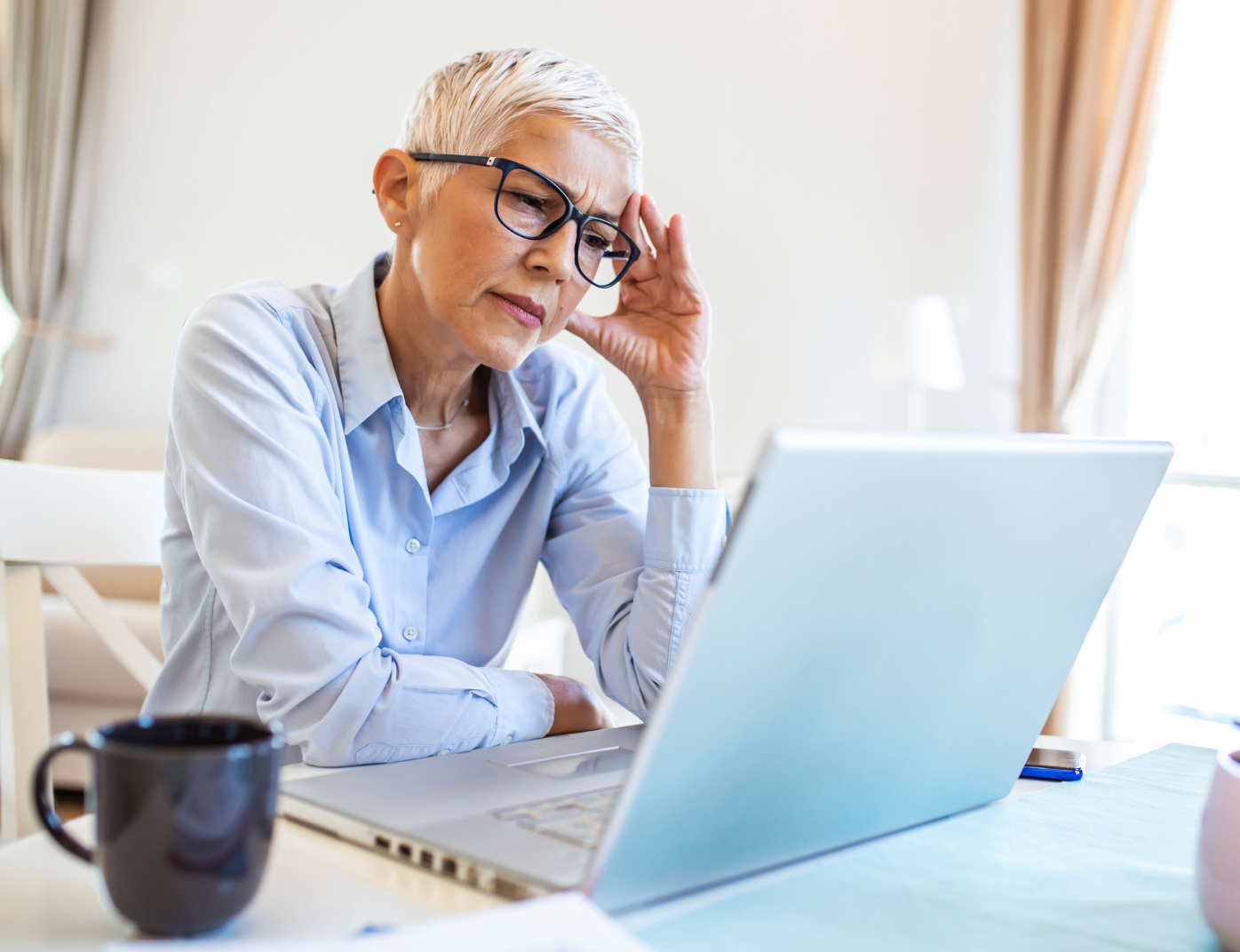 Frustrated woman looking at laptop