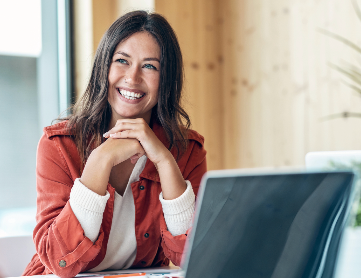 Smiling woman at desk feeling energetic